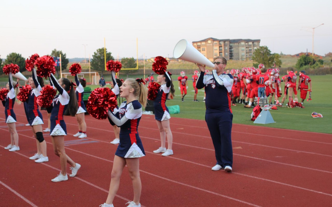 Cheerleaders at Liberty High School rally a crowd during a game.